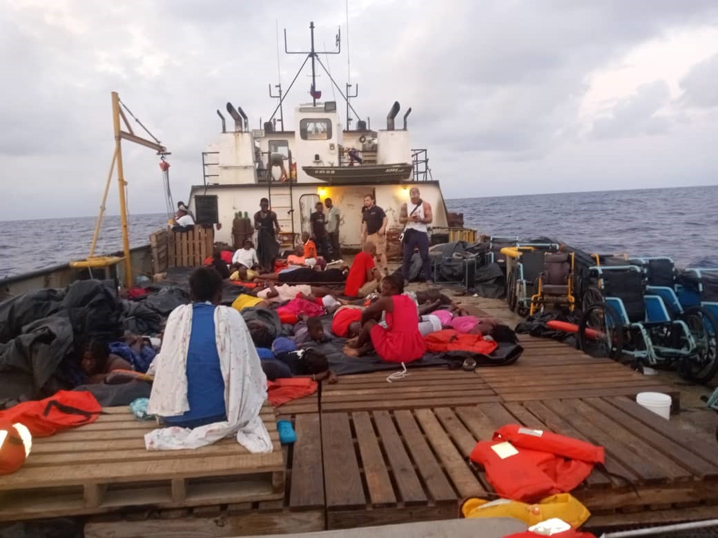 A group of people sitting on top of a boat.